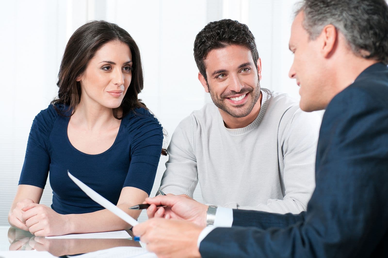 A consultant walks a couple through paperwork.