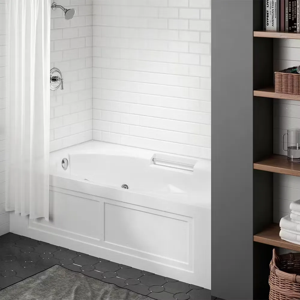 A dark gray bathroom with a white combination shower bathtub, white subway tile walls, and chrome fixtures.